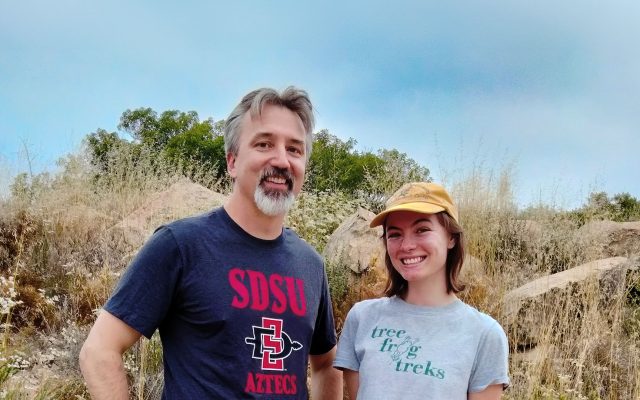 Rulon Clark and Emma Mc Andrews near a hillside.