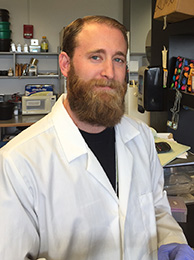 Darin Abbadessa in lab coat inside lab.