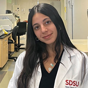 Closeup of Cecilia Gallo in a lab wearing a lab coat.