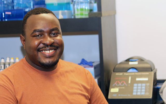 Trevor Mugoya sitting in lab.