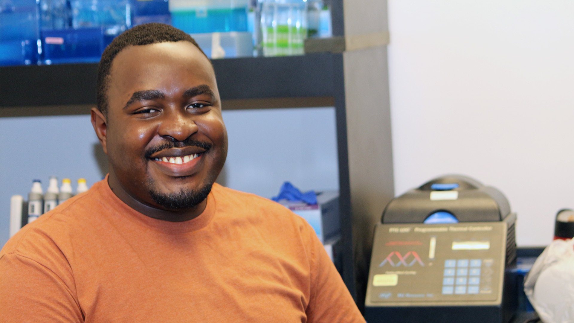 Trevor Mugoya sitting in lab.